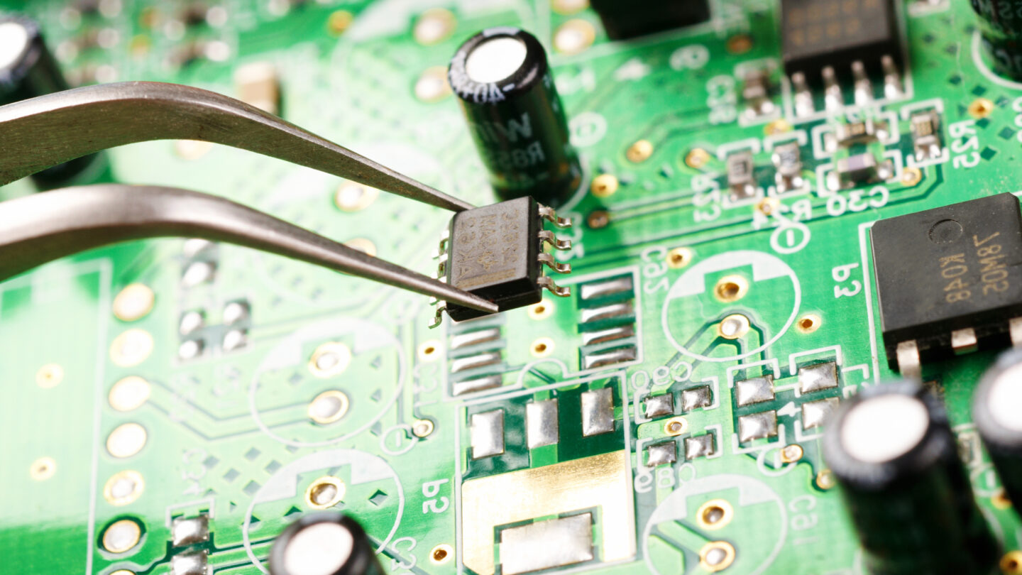 Closeup of a person assembling a circuit board